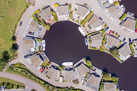 Aerial top shot from houses with boats in Friesland the Netherlandsの写真素材