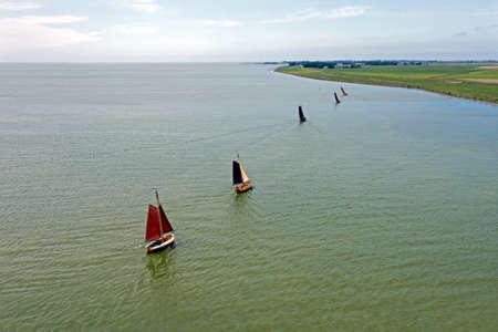 Aerial from traditional dutch wooden boats at the IJsselmeer near the harbor from Laaxum in Friesland the Netherlandsの写真素材
