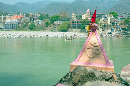 Ohm sign on a rock at the holy river Ganga near Rishikesh in India Asiaの写真素材