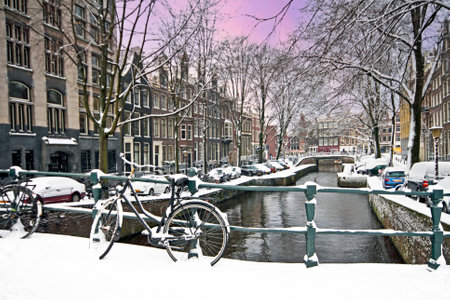 Amsterdam in winter in the Netherlands at sunsetの写真素材