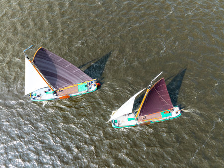 Aerial from historical wooden sailing boats, skutsjes on the Heegermeer in the Netherlandsの写真素材