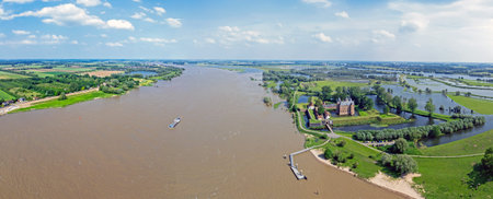 Aerial panorama from the river Merwede and castle Loevestein in a flooded landscape in the...