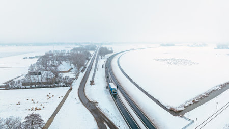 Traffic moving through a snowy rural landscapeの写真素材