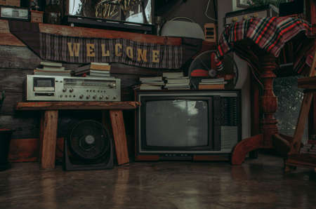 Antique and vintage style photo. retro televisions and radio pile on floor in old room for wallpaper decorative design.の写真素材