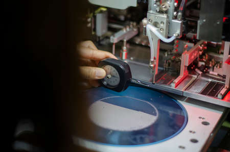 close up of a man holding a measuring machineの写真素材