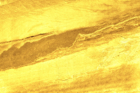 Gold grunge background. Gold stone background with copy space. Gold with rock texture.