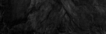 Panorama dark gray stone background with copy space. Black grunge banner with rock texture.The texture of the stone wall.の写真素材