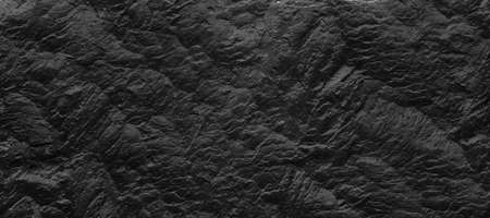 Dark gray stone background with copy space. Black grunge banner with rock texture.The texture of the stone wall.の写真素材