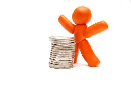 Plasticine figure staying in front of coins pile. Winner in businessの写真素材