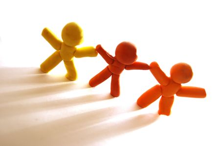 3 plasticine figures staying together and celebratingの写真素材