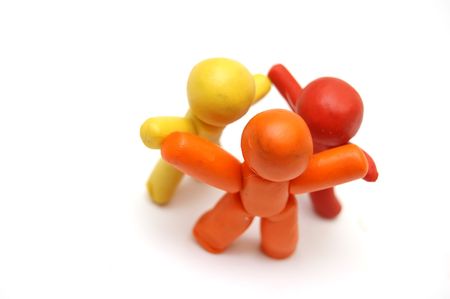 3 plasticine figures staying together and celebratingの写真素材