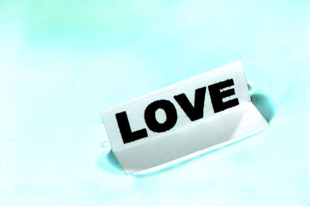 Card floating on water surface with printed word: LOVEの写真素材