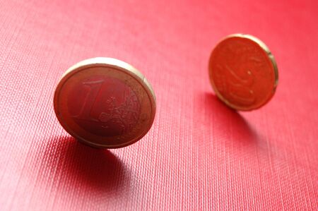 Euro coins on red surfaceの写真素材