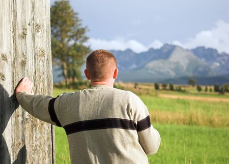 Man looking at mountains sceneryの写真素材
