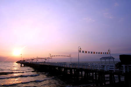 View of sunrise ocean with pierの写真素材