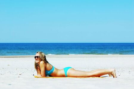Beautiful woman relaxing on the beach. Lots of useful copyspaceの写真素材