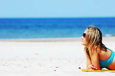 Beautiful woman relaxing on the beach. Lots of useful copyspaceの写真素材