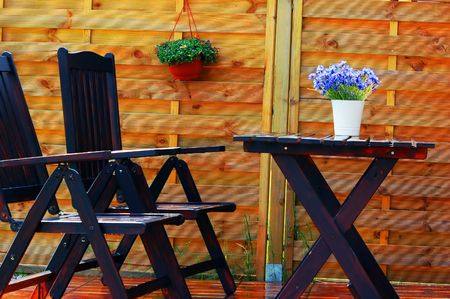 Outdoor design composed with wooden furniture and flowersの写真素材