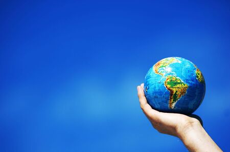 Earth globe in hand protected. Ideal for Earth protection concepts, recycling, world issues, enviroment themesの写真素材