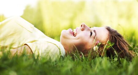 Pretty smiling girl relaxing outdoorの写真素材