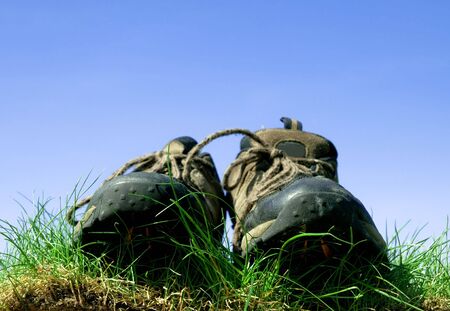 Shoes standing on grass. Conceptual imageの写真素材