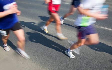 Running fast in marathon, legs close up. Sport, competition, energy.の写真素材