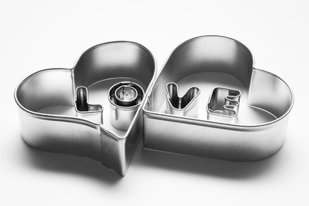 Love message in two hearts. Made of chrome metallic letters on white backgroundの写真素材