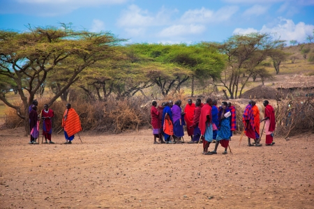 Maasai village, TANZANIA, AFRICA - DECEMBER 11: A group of Maasai people in traditional clothes in front of their village on December 11, 2012 in Tanzania. Maasai people are among the best known of African ethnic groups, due to their residence near the maのeditorial素材