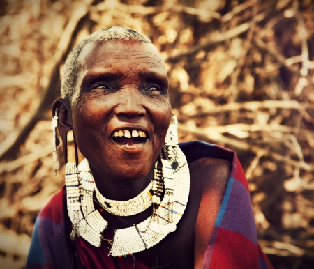 Maasai village, TANZANIA, AFRICA - DECEMBER 11: Maasai old woman laughing portrait in traditional clothes on December 11, 2012 in Ngorongoro Tanzania. Maasai people are among the best known of African ethnic groups located in Kenya and northern Tanzania.のeditorial素材