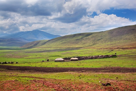 Savannah landscape in Tanzania, Africa. Maasai houses in the valleyの写真素材