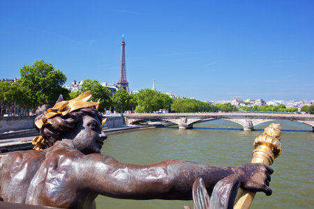 Eiffel Tower and bridge on Seine river in Paris, France. Artistic statue on Alexandre Bridgeのeditorial素材