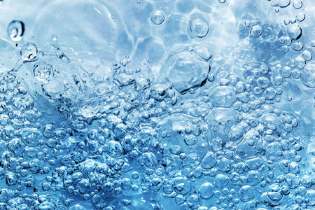 Clean fresh water with bubbles appearing when pouring water or a splash. Natural background