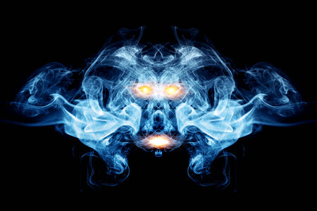 Abstract face made of smoke, flames  May be the concept of ghost, devil, logo element, backgroundの写真素材