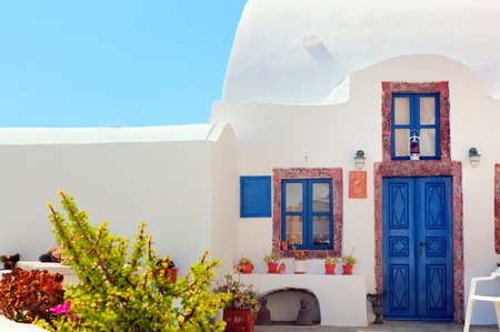 Traditional Greek house with blue door and windows, Santorini island, Greece. の写真素材