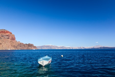 Blue and white boat on the Aegean sea. Therasia island near Santorini, Greece. の写真素材