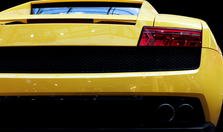 Modern fast car close-up background. Luxury, expensive, sports auto. Rear view.の写真素材