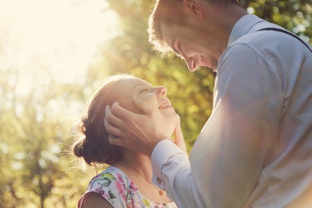 Young romantic couple flirting in sunshine. Dating, love, romance, vintage flare.の写真素材