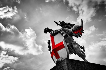 St George dragon statue in London, the UK. Symbol of England. Black and white with red St. George's Cross St George dragon statue in London, the UK. Symbol of England. Black and white with red St. George's Cross