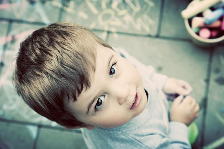 Creative boy painting on floor. Learn and play, Child expresses his creativity and emotions. Vintageの写真素材