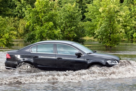 GDANSK, POLAND - July 28: Car trying to drive against flood on the street on July 28, 2015 in Gdansk, Poland. Storms and heavy rains hit many parts of Poland and Europeのeditorial素材