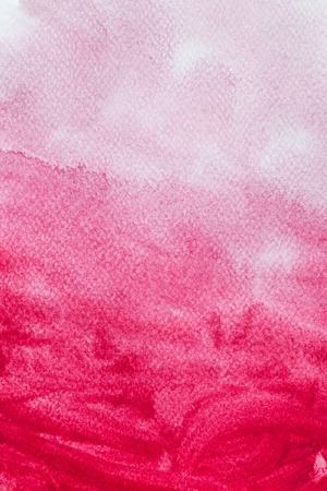 Red watercolor paint on canvas. Abstract art background for creative design.の写真素材
