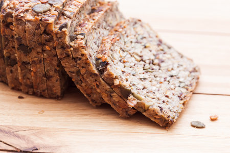 Wholemeal, wholewheat bread on wooden table. Organic, healthy food, breakfast.