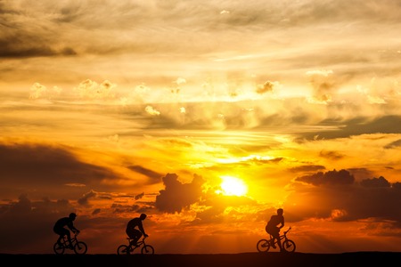 Friends on a bike trip at sunset. Active lifestyle, cycling hobby. freedom and health.の写真素材