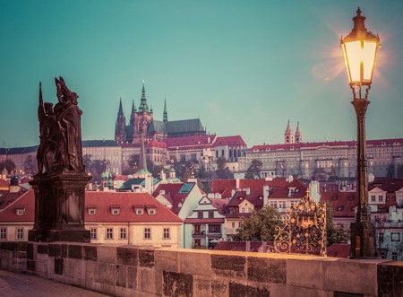 Charles Bridge at sunrise, Prague, Czech Republic. Dramatic statue and view on Prague Castle with St. Vitus Cathedral. Vintageのeditorial素材