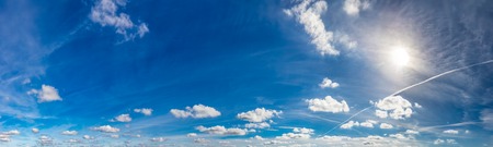 Blue sunny sky with fluffy clouds. Huge panorama imageの写真素材