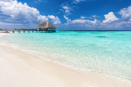 Maldives islands resort on Indian Ocean. Wooden jetty with water relaxation lodge.の写真素材