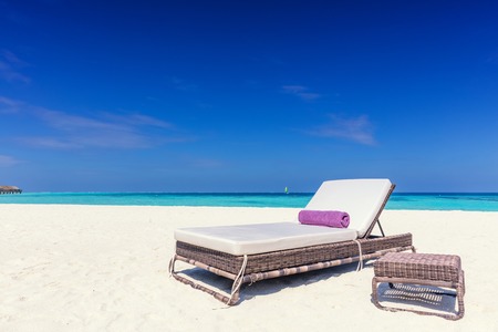 Deckchair on sandy tropical beacha a small island resort in Maldives, Indian Ocean. Holidays destinationの写真素材