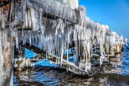 Icicle hanging under jetty roof. Ice, winter timeの写真素材