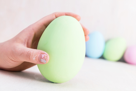 Hand holding one pastel Easter egg. Selective focusの写真素材