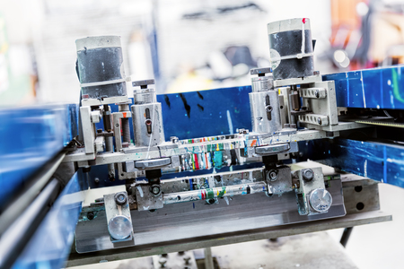 Print screening metal machine. Industrial printer. Serigraphy workshop.の写真素材